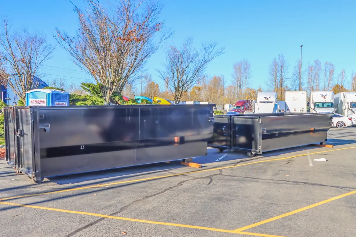 Professional dumpster rental service with roll-off container on residential driveway in Riviera Beach